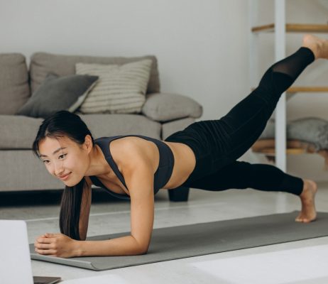 woman-doing-yoga-plank-home-mat