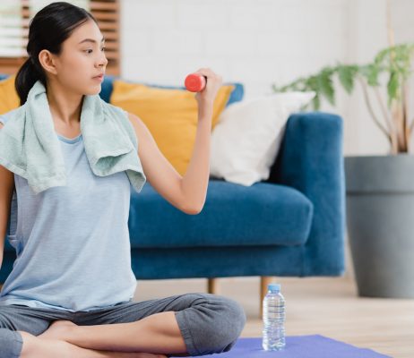 young-asian-woman-practicing-yoga-living-room